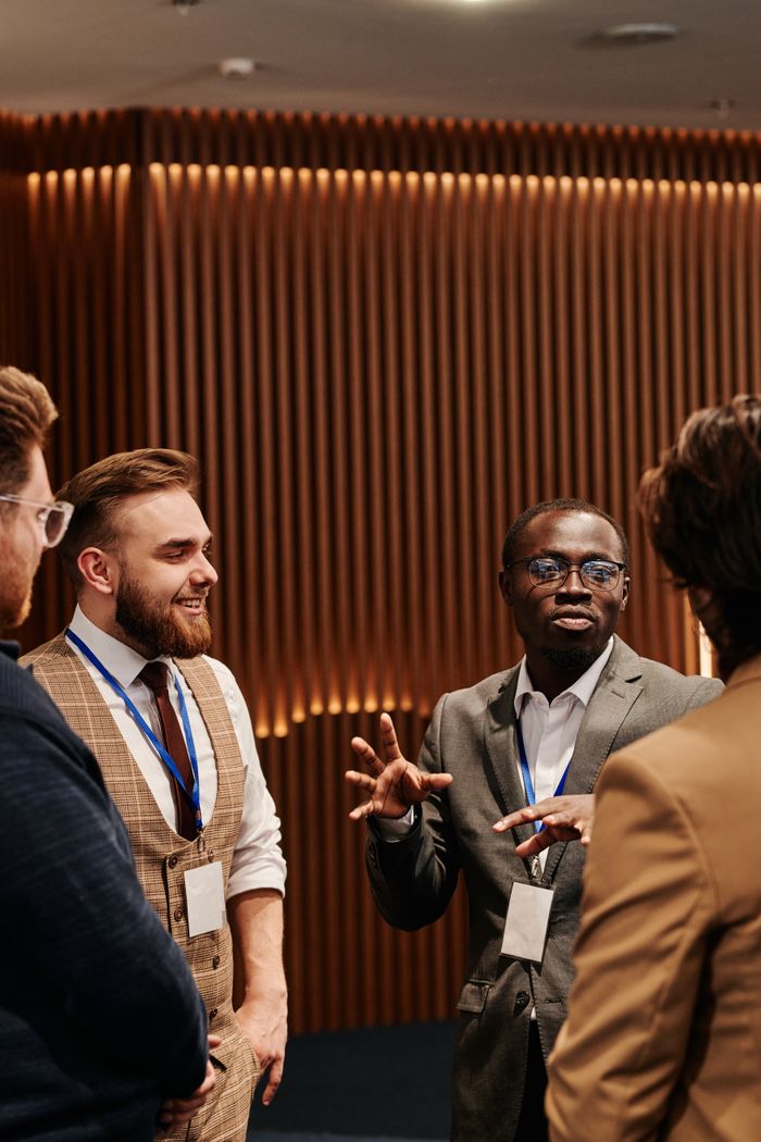 Business professionals in corporate attire having a lively discussion indoors.